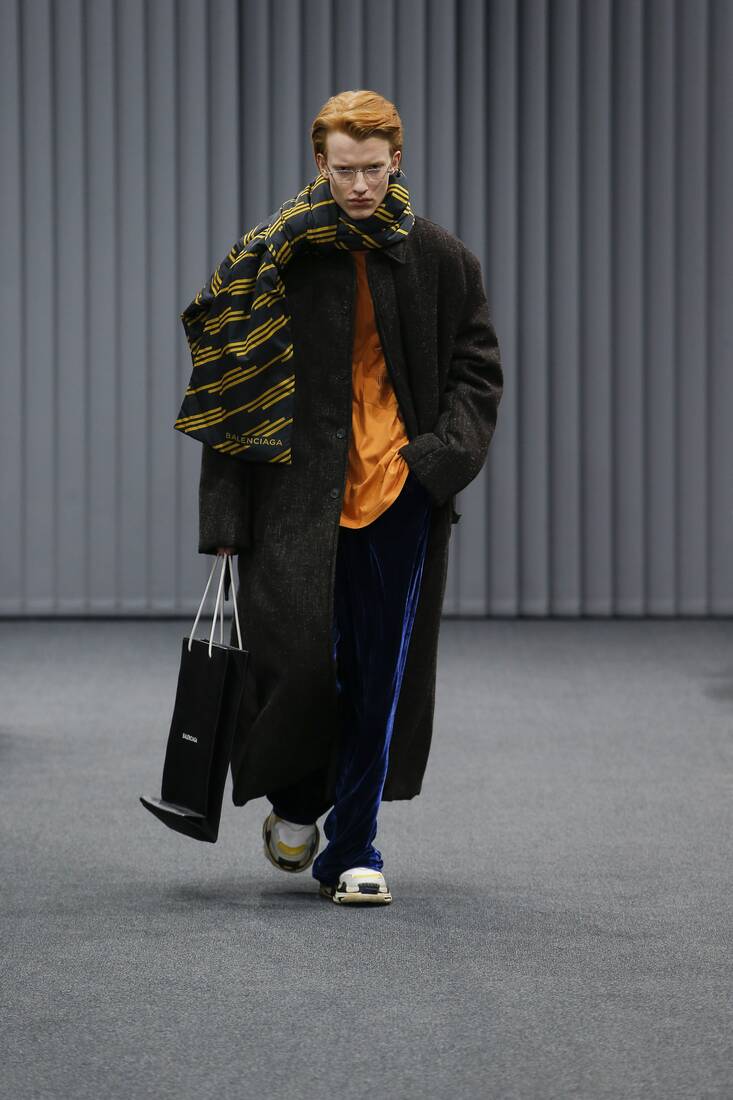 Lexica  Arab male model walking dow the catwalk fashion streetwear  oversized balenciaga gray tones
